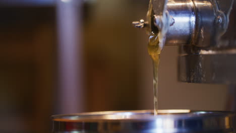 Honey-Pouring-into-Jar-in-Apiary