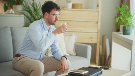 Happy-Businessman-Works-on-Tablet-and-Drinks-Water