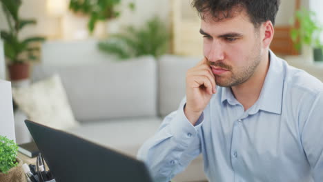 Wondering-Businessman-Working-on-Laptop