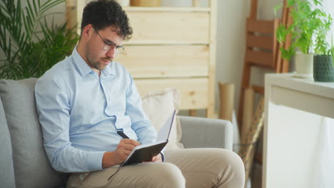 Businessman-Organizes-Meetings-in-Notebook