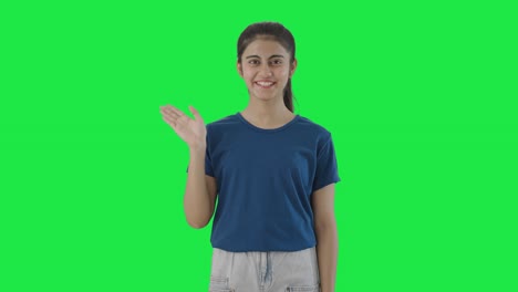 Happy-Indian-teenage-girl-waving-Hi-to-the-camera-Green-screen