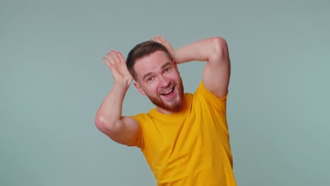 Lovely-funny-man-smiling-friendly,-doing-bunny-ears-gesture-on-head-having-fun-fooling-comical-mood