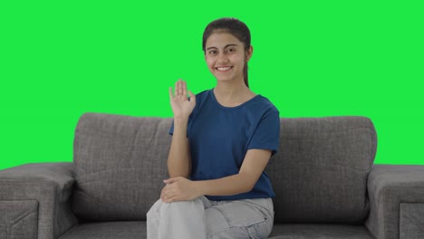 Happy-Indian-teenage-girl-saying-Hello-to-the-camera-Green-screen