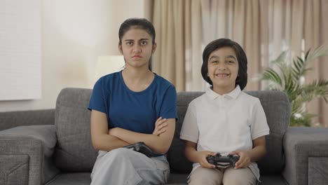 Indian-boy-teasing-sister-after-winning-video-game