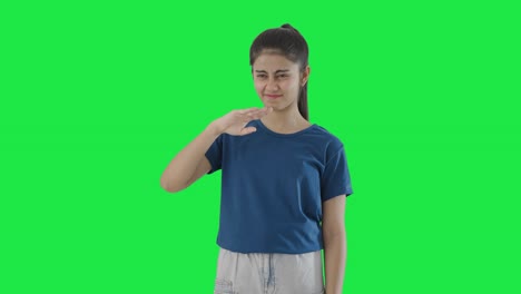 Indian-teenage-girl-disgusted-by-bad-smell-Green-screen