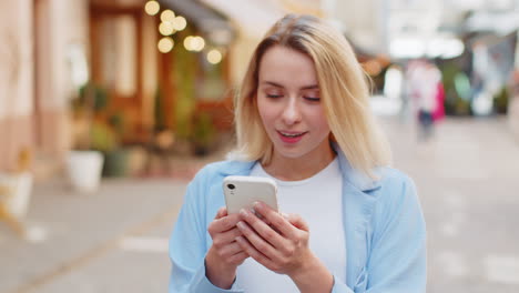 Excited-happy-winner-woman-use-smartphone-looking-amazed-at-screen-celebrating-win-good-message-news