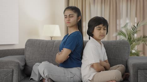 Angry-Indian-siblings-sitting-back-to-back-and-not-talking