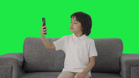 Indian-boy-talking-on-video-call-Green-screen