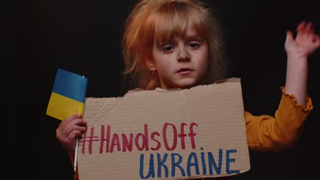 Portrait-of-Ukrainian-girl-child-with-massage-inscription-text-on-map-Hands-Off-Ukraine,-crisis,-war