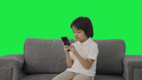 Serious-Indian-boy-chatting-with-someone-on-phone-Green-screen