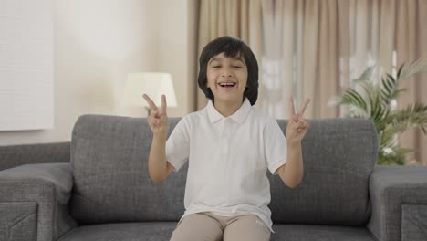 Happy-Indian-boy-showing-victory-sign