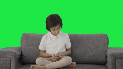 Indian-boy-counting-money-coins-Green-screen