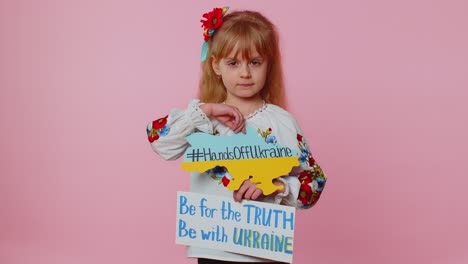 Sad-toddler-Ukrainian-girl-kid-in-embroidery-protesting-war-conflict-raises-banner-with-inscription