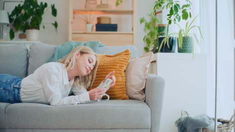 Girl-Surfs-Internet-on-Sofa