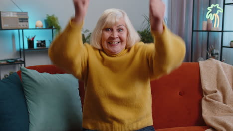 Excited-grandmother-woman-surprised-shocked-by-sudden-victory-good-win-news-celebrating-wow-reaction