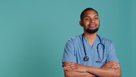 Portrait-of-jolly-male-caregiver-standing-with-arms-folded