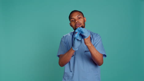 Portrait-of-nurse-putting-on-protective-latex-gloves