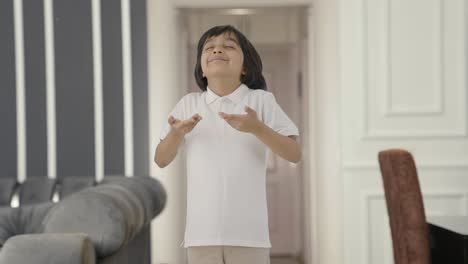 Indian-boy-doing-breathe-in-breathe-out-exercise