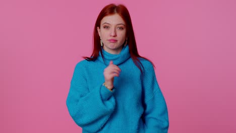 Teen-redhead-girl-in-blue-sweater-showing-thumbs-up-and-nodding-in-approval,-successful-good-work