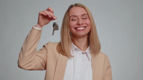 Businesswoman-real-estate-agent-showing-the-keys-of-new-home-house-apartment-renting-buying-property