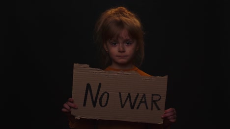 Upset-poor-toddler-child-girl-homeless-protesting-war-conflict-raises-banner-with-inscription-No-War