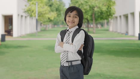 Portrait-of-Happy-Indian-school-boy-standing-crossed-hands