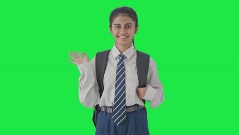 Happy-Indian-school-girl-waving-Hi-to-the-camera-Green-screen