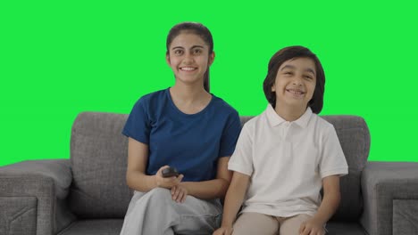 Happy-Indian-siblings-watching-TV-Green-screen