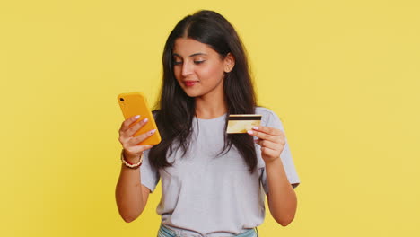 Indian-woman-use-credit-bank-card-smartphone-transferring-spending-money-purchases-online-shopping