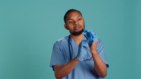 Portrait-of-nurse-putting-on-protective-latex-gloves