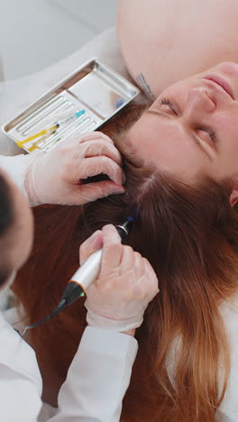 Trichologist-doing-woman-hair-regeneration-procedure,-dermapen-microneedling,-vitamin-injections