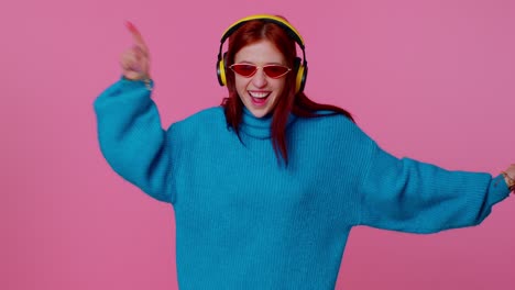 Cheerful-attractive-girl-listening-music-via-headphones-and-dancing-disco-fooling-around-having-fun