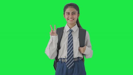 Happy-Indian-school-girl-showing-victory-sign-Green-screen