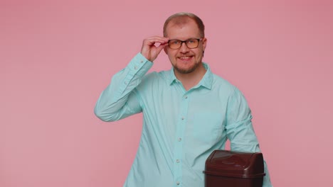 Smiling-man-taking-off,-throwing-out-glasses-into-bin-after-vision-laser-treatment-therapy