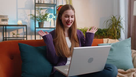 Woman-sitting-on-home-couch,-looking-at-camera,-making-video-conference-call-with-friends-or-family