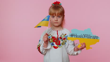 Upset-toddler-Ukrainian-girl-protesting-war-conflict-raises-inscription-massage-Hands-Off-Ukraine