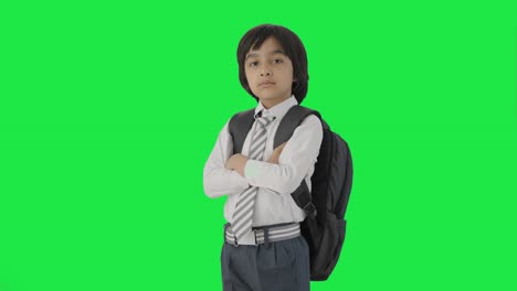 Portrait-of-Confident-Indian-school-boy-standing-crossed-hands-Green-screen