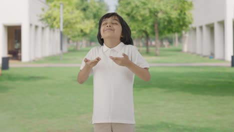 Indian-boy-doing-breathe-in-breathe-out-exercise-in-park