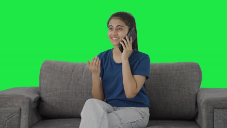 Happy-Indian-teenage-girl-talking-on-call-Green-screen