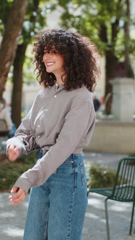 Happy-young-woman-smiling-turning-looking-at-camera-resting-good-news-feel-satisfied-on-city-street