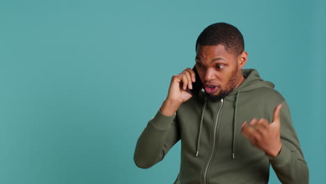 Man-enjoying-talking-with-friends-in-phone-call-using-smartphone