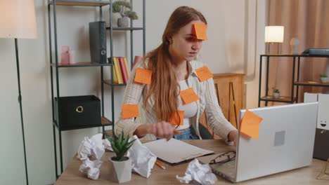 Exhausted-woman-freelancer-with-pasted-stickers-using-laptop-having-concentration-problem-in-office