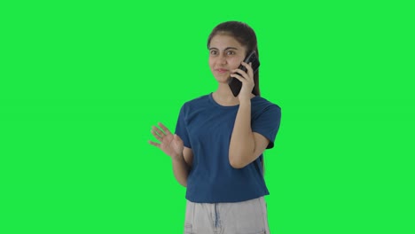 Happy-Indian-teenage-girl-talking-to-someone-on-call-Green-screen