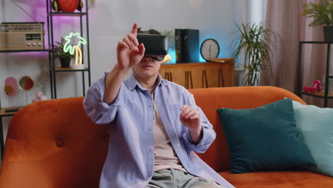 Man-using-virtual-reality-futuristic-technology-headset-to-play-simulation-3D-video-game-at-home