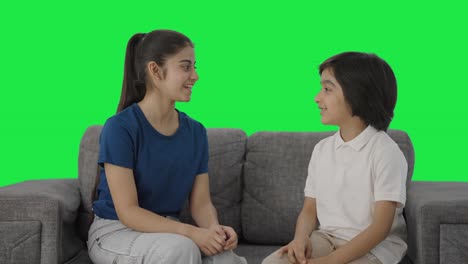 Happy-Indian-siblings-talking-to-each-other-Green-screen