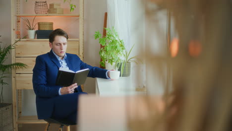 Businessman-Reads-While-Drinking-Coffee