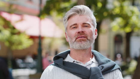 Portrait-of-happy-bearded-mature-man-smiling-friendly,-glad-expression-looking-at-camera-relaxation