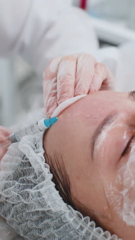 Cosmetologist-making-woman-beauty-anti-aging-injections-biorevitalization-face-forehead-mesotherapy