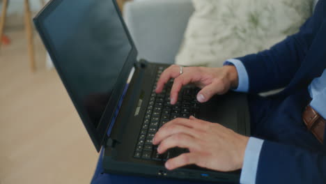 Businessman-Answers-Emails-on-Laptop