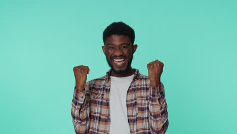 African-american-man-shouting,-raising-fists-in-gesture-I-did-it,-celebrating-success,-winning